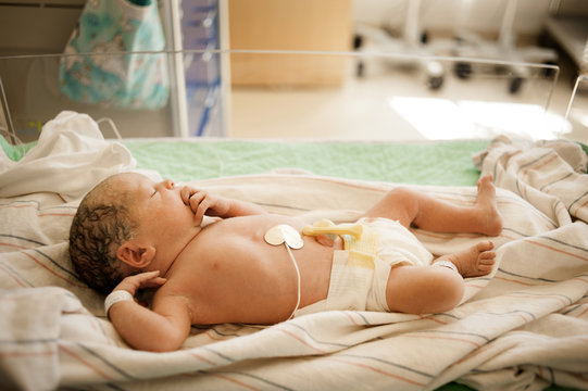 High angle view of newborn baby girl sleeping in hospital