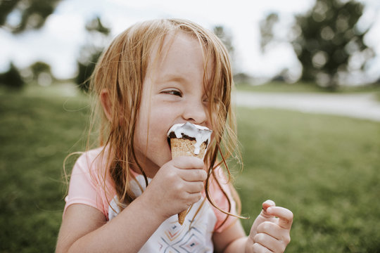 Close up of girl eating an ice cream outdoors