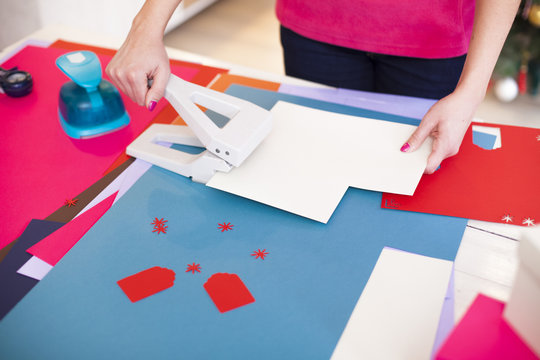 Young woman make scrapbook of the papers on the table using anti