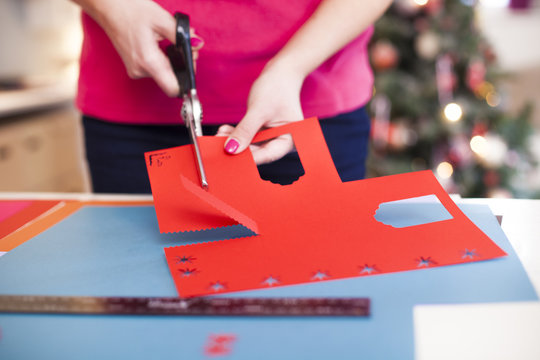 Young woman make scrapbook of the papers on the table using anti