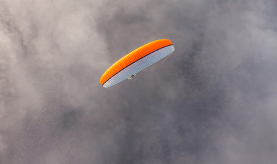 aerial view of paramotor flying over the clouds