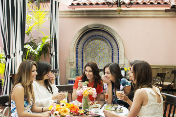 Cheerful females talking at outdoor restaurant