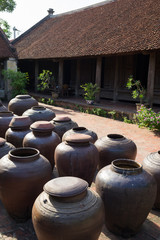 Jars of Tuong in ancient house yard, a kind of fermented bean paste made from soybean and commonly used in Vietnamese cuisine