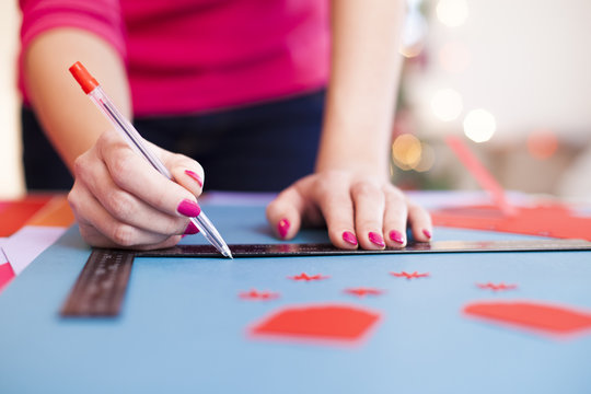 Young woman make scrapbook of the papers on the table using anti