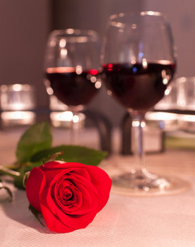 Red rose in a romantic dinner setting. 