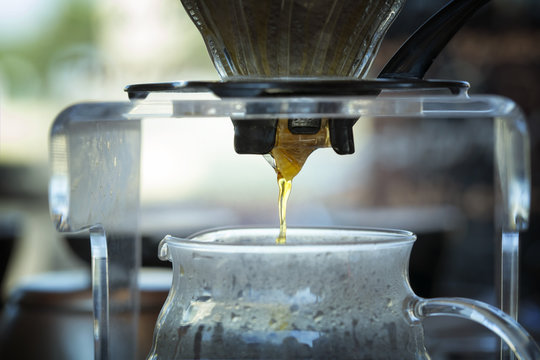 Close-up of beer being poured in glass jug in a bar