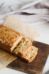 Glazed applesauce oatmeal bread on a white marble table