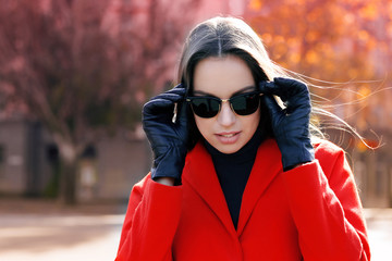 Beautiful young woman wearing sunglasses on autumn day