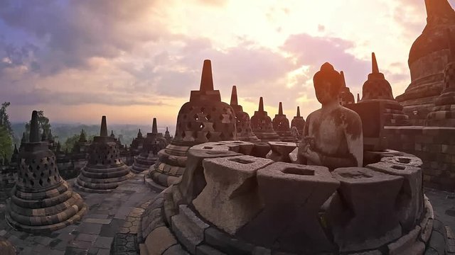 Borobudur temple java Indonesia. Mahayana Buddhist world's largest temple in Magelang. Central dome surrounded by Buddha statues, each seated inside perforated stupa. Buddhism architecture