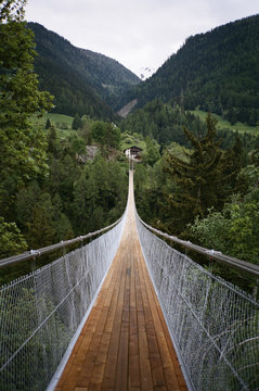 High angle view of footbridge over forest against mountains