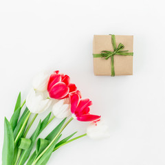 Bouquet with tulip flowers and gift isolated on white background. Flat lay,