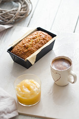 Glazed applesauce oatmeal bread on a white marble table