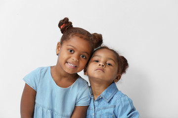 Two cute African girls posing on white background