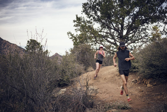 Sporty couple running on mountain