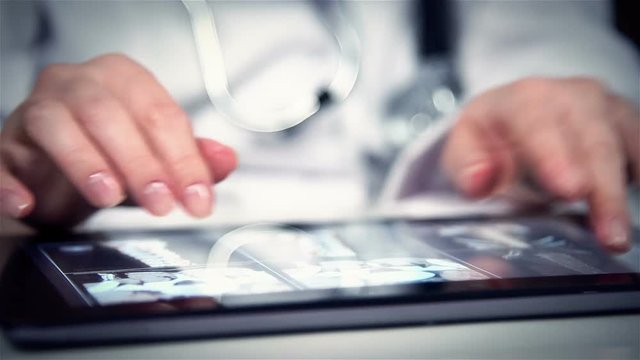 Doctor Examines An X-ray Of Patient On Digital Tablet