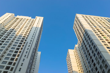 Obraz premium Resident apartment buildings against blue sky. Real estate background