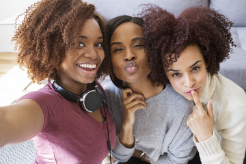 Portrait of playful female friends at home
