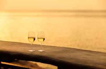 Pair of wine glasses by the sea.