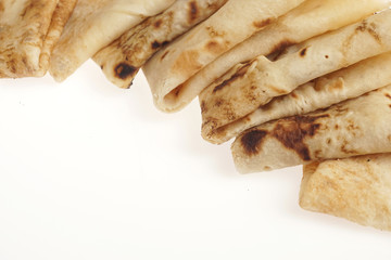 Freshly baked rolled blinis or crepes isolated