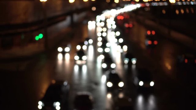 Traffic jam car lights. Street at night from a bridge. Cars passing by. Dark evening.