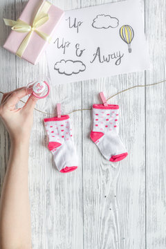 birth of girl - baby shower concept on wooden background