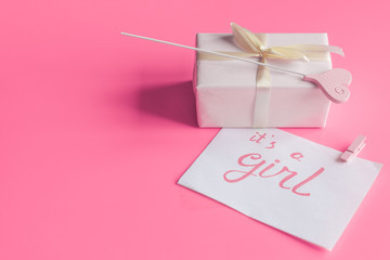 baby's bootees and gift box on wooden background