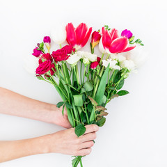 Bouquet with beautiful flowers in hands isolated on white background. Flat lay,
