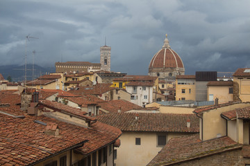 Fototapeta na wymiar Red roofs and Florence Cathedral on background. Tuscany. Italy.
