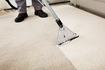 Person Cleaning Carpet With Vacuum Cleaner - obrazy, fototapety, plakaty