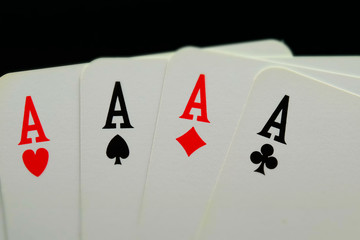 Poker: Four of a kind, aces. Tilt-shift effect applied.
