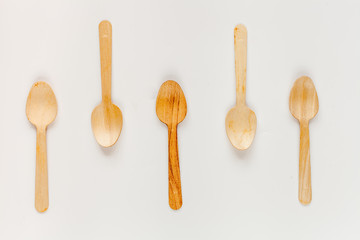 wooden kitchen utensils on white background top view pattern