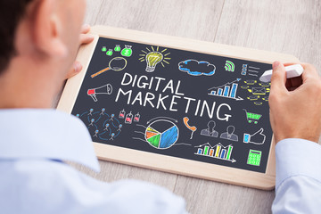 Businessperson Drawing Digital Marketing On Slate