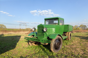 Fototapeta premium Vintage retro green truck in the field