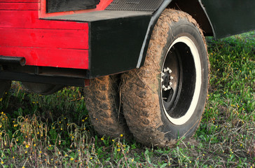 Fototapeta na wymiar Muddy dual wheel retro truck closeup in a countryside