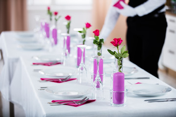 Male Waiter Placing Napkin