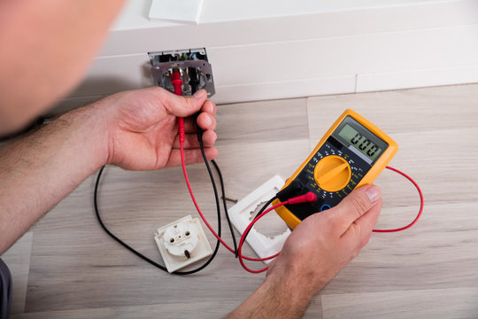 Person's Hand Holding Multimeter
