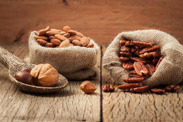 Almonds in bags on the old wooden floor.