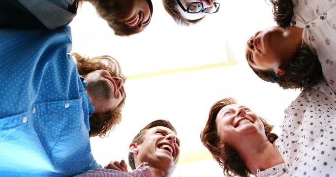Businesspeople forming huddle