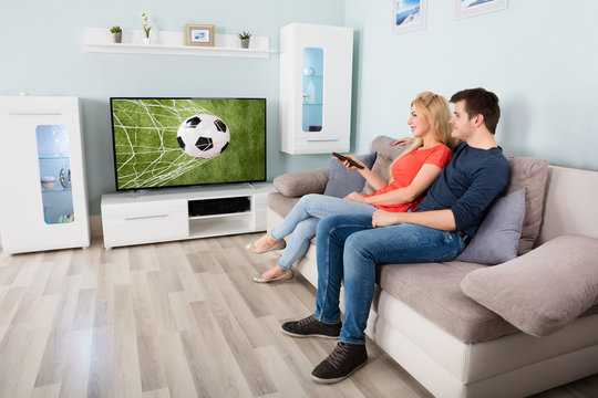 Couple Watching Football Game On Television
