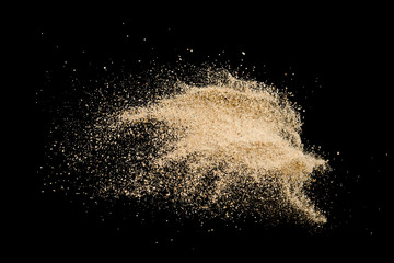 Sand explode on black background ,stop motion