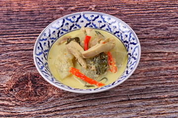 Green chicken curry in coconut milk with winter melon .