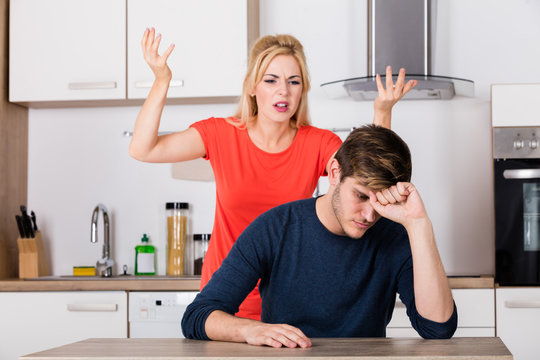 Woman Shouting To Her Husband In The Kitchen