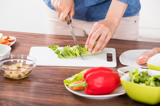 Close-up Of Woman Cutting Vegetable