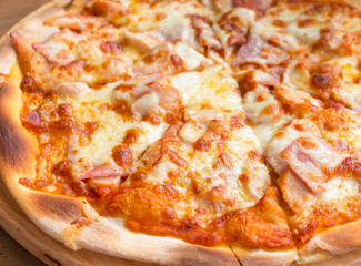 pizza slices on wooden plate