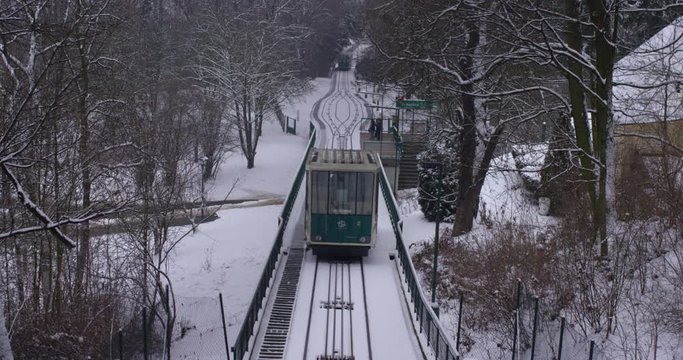 Prague Petrin funicular railway going down from Petrin hill station, Czech Republic. Slow motiom winter