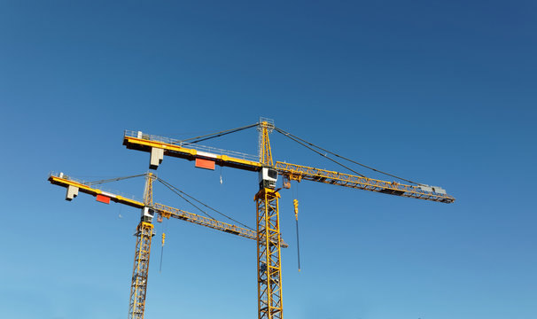 Sihouette Of Yellow Cranes And Blue Sky