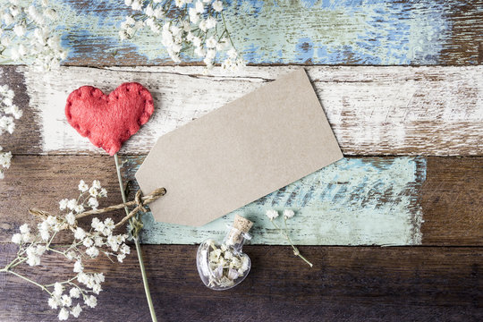 Love Concept Of Blank Brown Paper Tag With Red Heart And Flowers On Old Wood For Valentines Day And Wedding