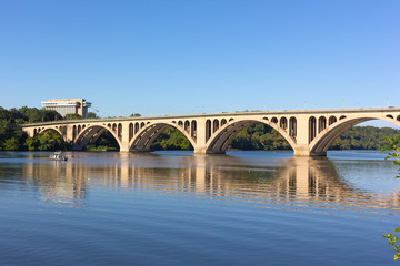 Key Bridge with reflection in Potomac River in Washington DC, USA. Quiet waters of Potomac River in early morning near the scenic bridge.