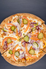 pizza is on a black background, with vegetables