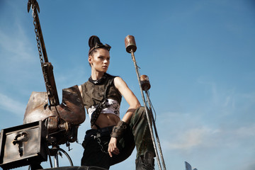 Woman warrior in futuristic clothes with car